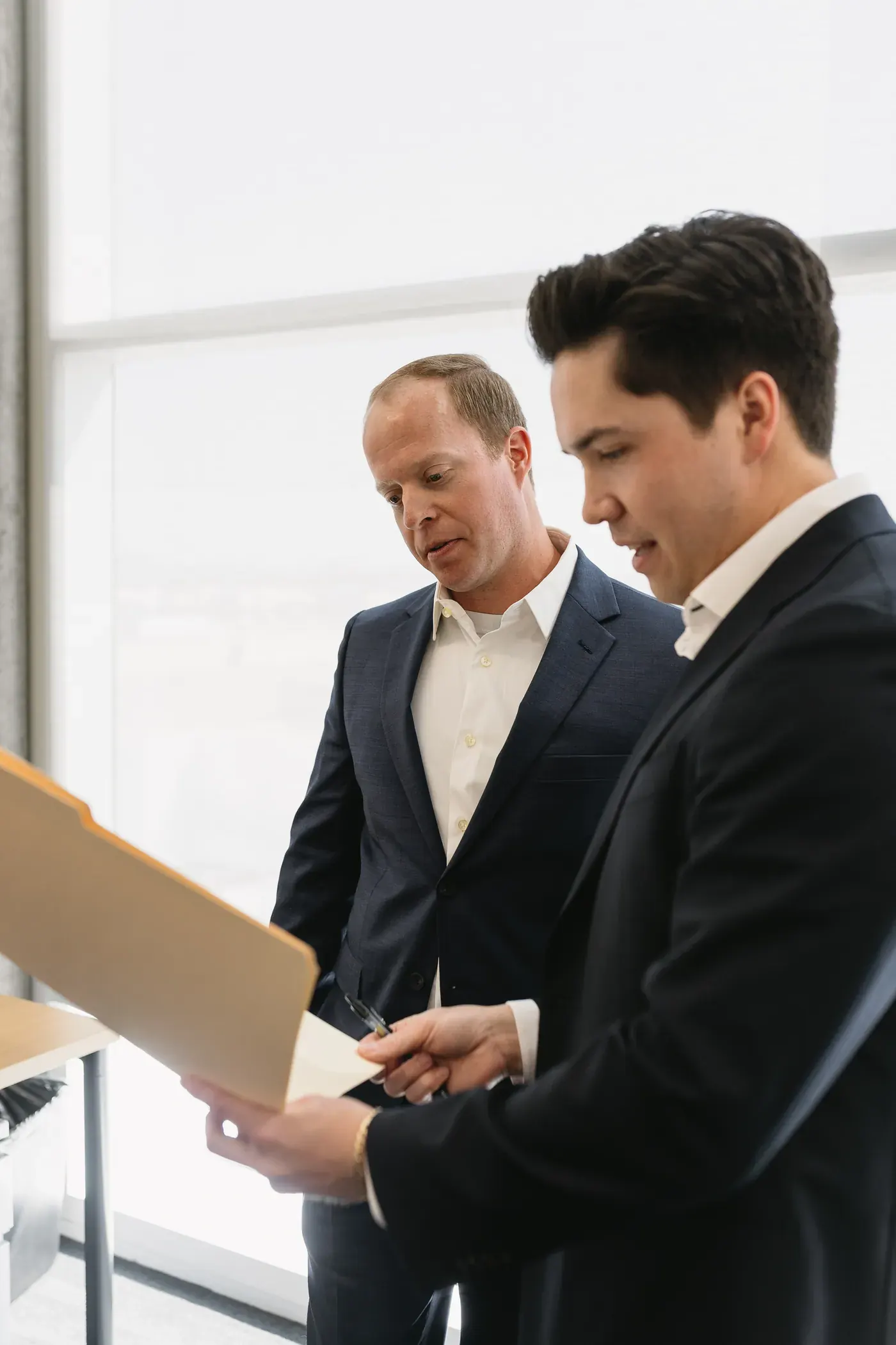 Two attorneys reviewing a file together