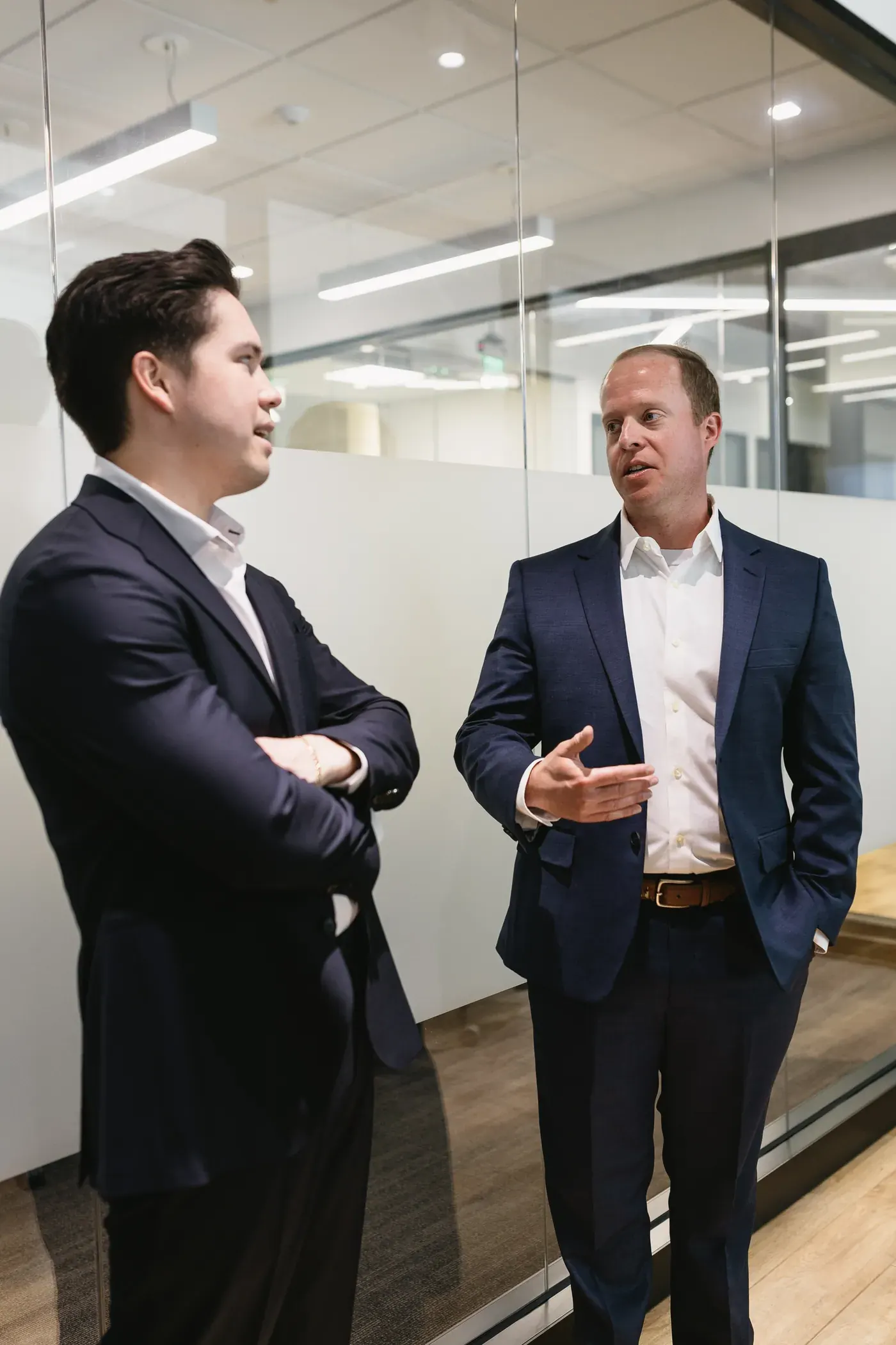 Two Peters Kussmaul Crosier attorneys talking in the office